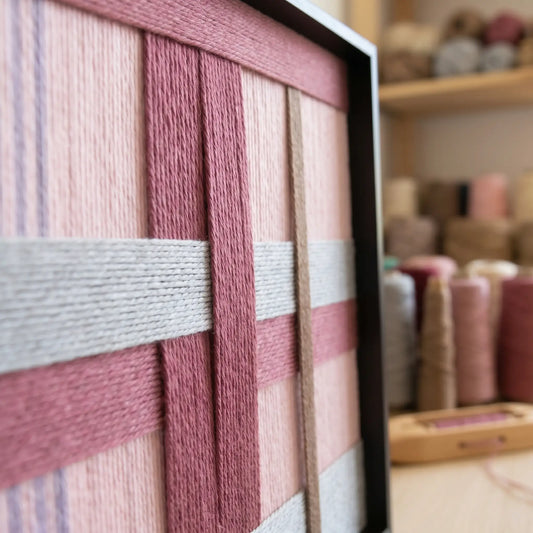 Angled close-up of Bloom Forecast SQ095 highlighting hand-wrapped yarn texture and dimensional structural layering.