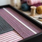 Macro view of Burgundy Overture SQ098 showing deep plum, charcoal gray, and striped pink soft cotton cord texture.