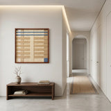 Breathing Shallows SQ105 textured yarn wall art displayed above a wooden bench in a minimalist hallway.