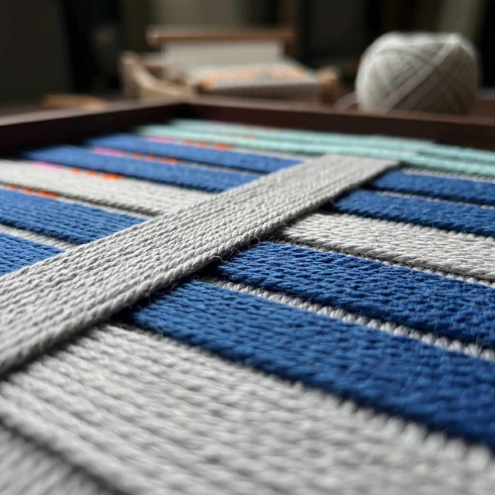 Macro view of Silent Dopamine SQ108 showing raised gray yarn layered over horizontal cobalt blue bands.