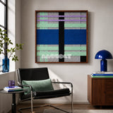 Winter Aurora SQ112 framed textile art with light gray, black, cobalt blue, mint green, and lavender yarn.