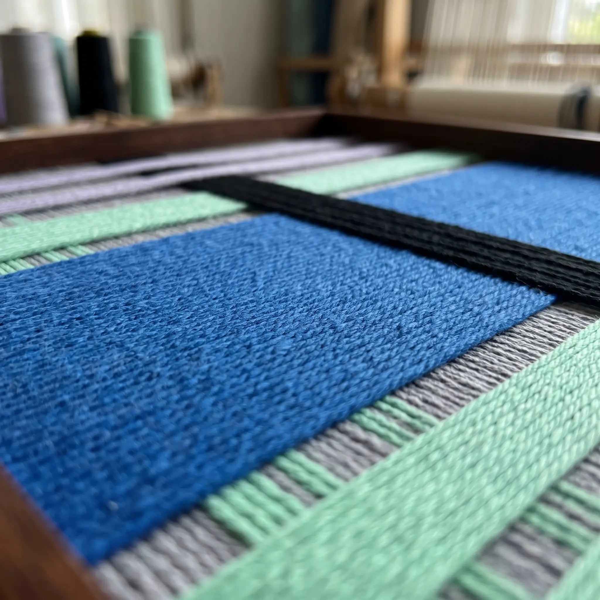 Extreme close-up of Winter Aurora SQ112 showing dense cobalt blue and black soft cotton cord texture.