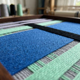 Extreme close-up of Winter Aurora SQ112 showing dense cobalt blue and black soft cotton cord texture.