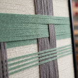 Macro view of Muted Spring SQ115 showing raised sage green yarn over gray and cream vertical bands.