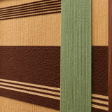 Close-up of Cedar and Sage SQ119 showing raised sage green yarn layered over cedar brown and golden beige bands.
