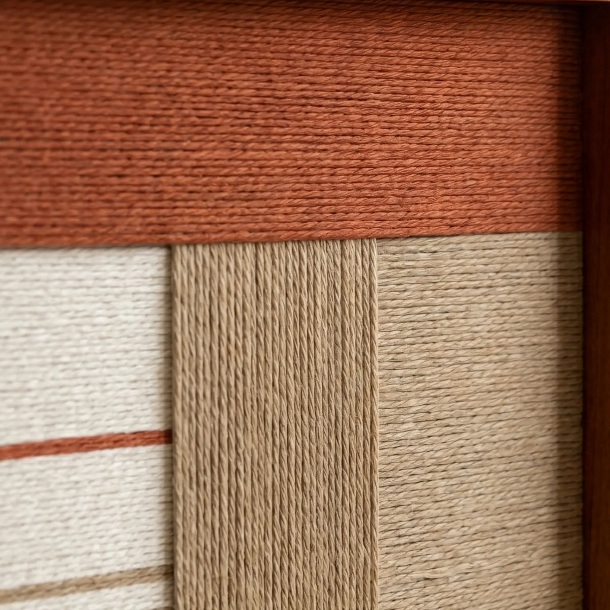 Close-up of Terracotta Haven SQ132 highlighting textured terracotta, beige, cream, and dark brown yarn blocks.