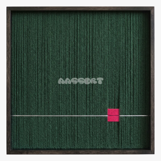 Forest Letter, framed textile wall art with a small pink block and fine pale line on forest green.