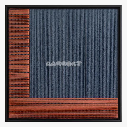 Held Space, framed textile wall art with navy blue fibers bordered by rust-orange bands.