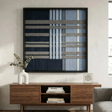 Sophisticated Starry Latitude hand-woven tapestry hanging above a wooden credenza in a modern living room with bright natural lighting.