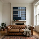 Starry Latitude framed wall art displayed in a warm living room above a classic brown leather sofa and patterned area rug.