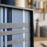Extreme macro close-up of the Starry Latitude hand-woven wool tapestry showing textured navy and icy blue geometric yarn details.