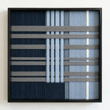 Frontal studio shot of the Starry Latitude square framed wall art featuring a sophisticated navy, blue, and cream geometric tapestry.