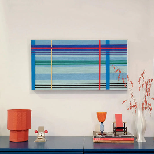Summer Story hand-woven wool yarn wall art with alternating turquoise, teal, and sky blue horizontal stripes and bold red accent lines in a natural wood frame

