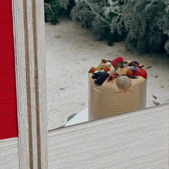Macro shot of The Sun Always Rises mirror art border revealing tight wool stitching and crisp transitions between oatmeal, natural, and red stripe panels.
