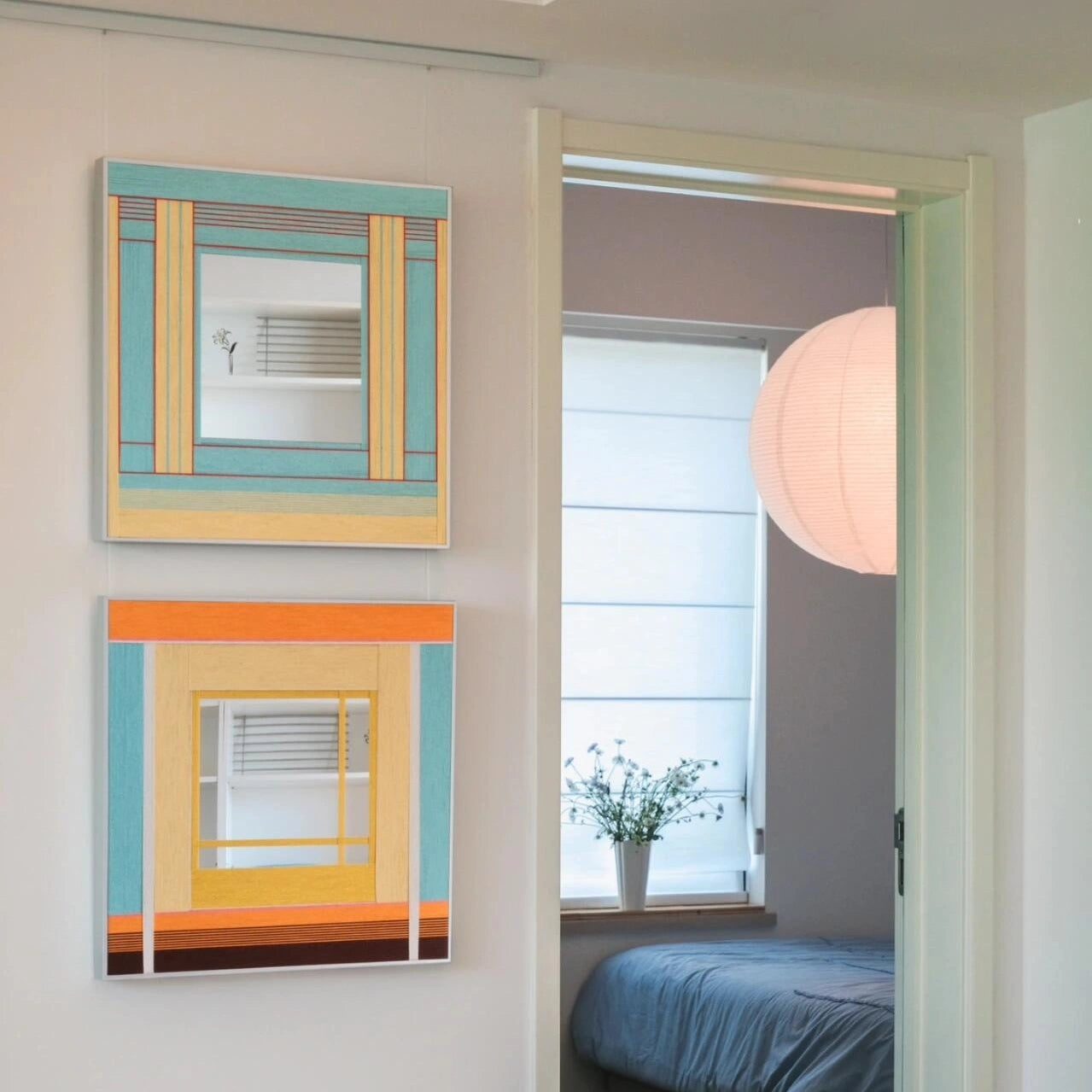 Sun‑Drenched Days yarn wall art mounted over a bedside table with books, highlighting its soothing stripe design for a restful space.
