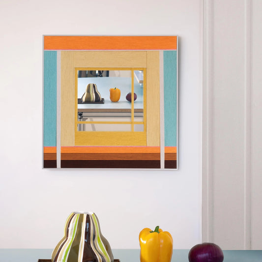 Sun‑Drenched Days yarn wall art styled on a desk beside notebooks and a ceramic cup, showcasing its soft stripe palette and clean frame.
