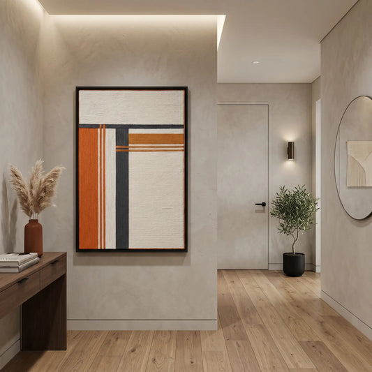 Hand-woven wool tapestry in sunset tones creating a vibrant focal point in a modern hallway with light wood flooring.