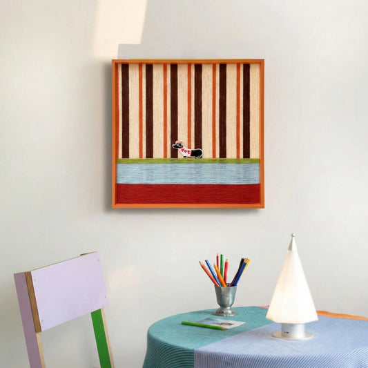 Framed textured fiber wall art styled above a colorful child's play table with a purple chair and creative supplies.