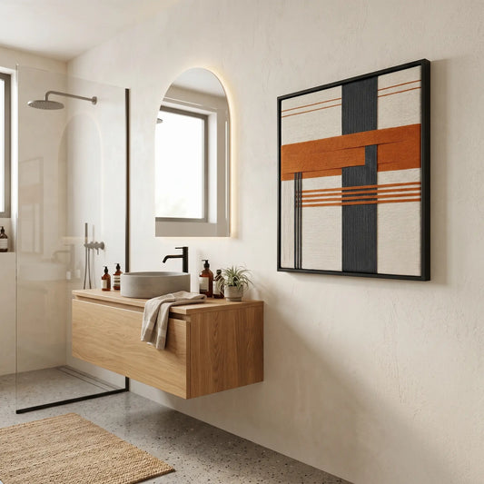 Large square Terracotta Dusk fiber wall art hanging in a modern luxury bathroom above a floating wooden vanity.