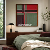 The Gift Ribbon red, moss green, dark brown, and white yarn wall art displayed above a bed in a cozy modern bedroom.