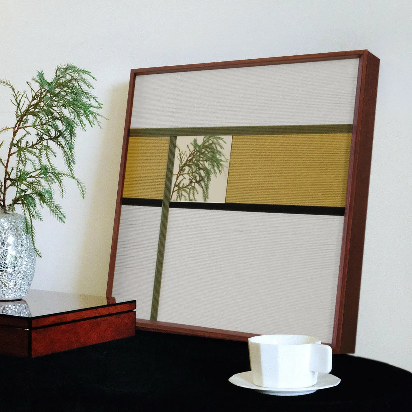 Through the Mirror mirror art displayed next to a teacup on a console, emphasizing clean wool stripe alignment and the crisp reflective panel.
