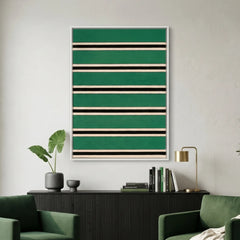Large vertical hand-woven wool wall art featuring horizontal stripes in forest green, black, and cream, hanging above a black sideboard flanked by two green armchairs.
