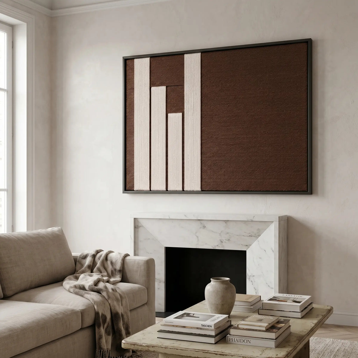 Timeless Trace hand-woven wool art displayed above a dark wood console table, styled with books and vases for a sophisticated interior look.