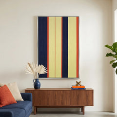 Large vertical hand-woven wool wall art with navy blue, yellow, and red stripes hanging above a walnut credenza in a modern living room.