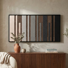 Earth-toned Umber Columns framed wall art styled above a warm wooden credenza adorned with a ceramic vase in a serene living space.