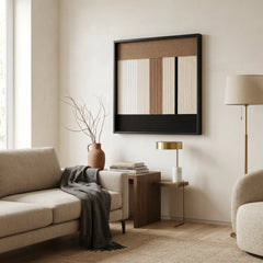 Large-scale textured fiber wall art hanging in a cozy living room setting with a beige sofa, gold floor lamp, and rug.
