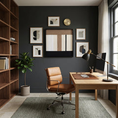 Hand-woven wool wall art featured in a gallery wall arrangement within a dark grey home office with a leather chair.