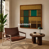 Vast Horizon geometric yarn wall art styled with a leather chair and side table in a warm reading corner.