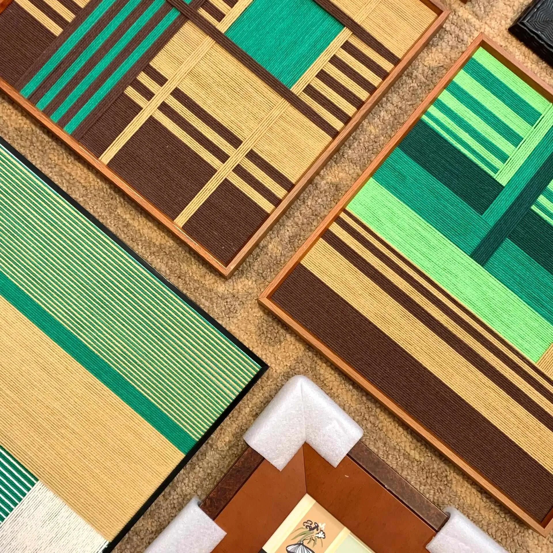Angled close-up of Vast Horizon wall art showcasing tight wool stitch detail and crisp transitions between stripe colors
