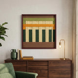 A close-up view of the soft cotton cord fiber artwork above a wooden sideboard featuring a gold lamp and green velvet armchair accents.