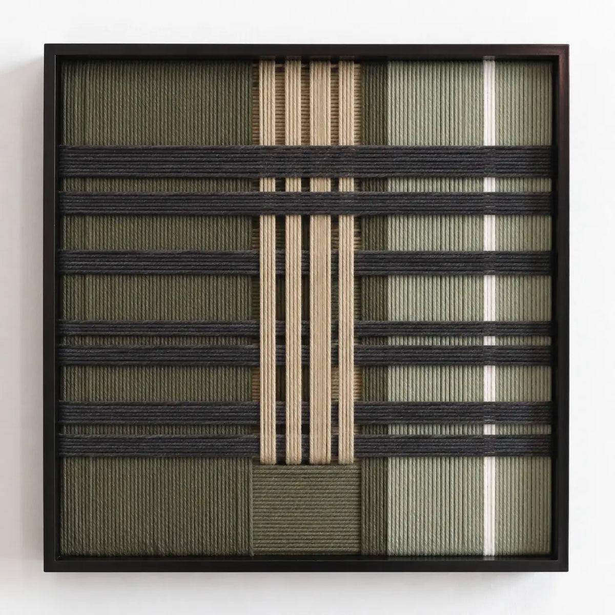 Frontal studio shot of the Verdant Silence square framed wall art featuring a sophisticated green, black, and cream geometric tapestry.