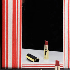 Close-up of Wave Tide mirror art capturing the smooth glass reflection and the crisp edge between the red wool stripe and black frame.
