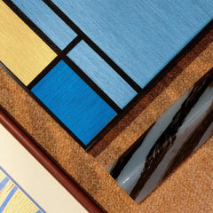 Macro close-up of Weave Reshape yarn wall art revealing looped wool texture and the precision of its grid pattern.
