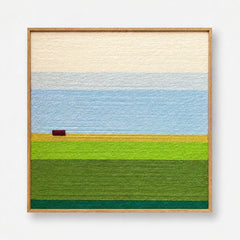 Full product view of the landscape hand-woven wool wall art framed neatly, showcasing cream sky and green fields.