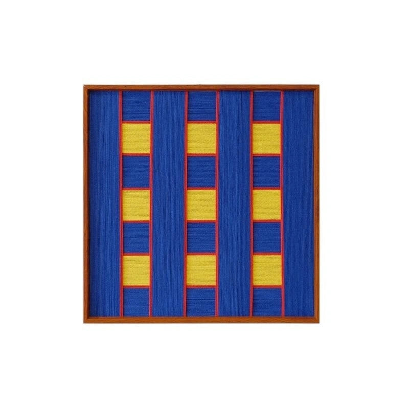 Front view of Moonlit Windows framed fiber wall art with royal blue panels, yellow blocks and red borders on a white background
