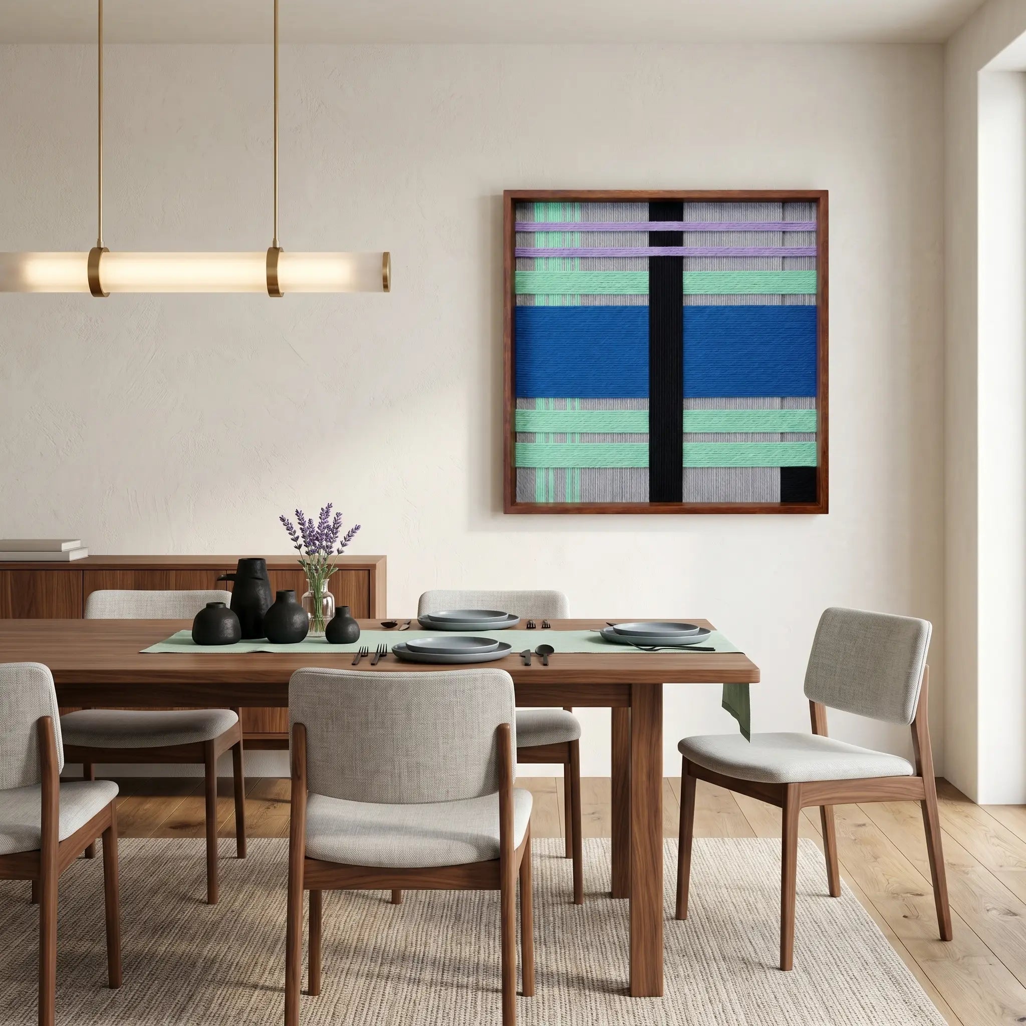 Vibrant geometric wool art piece creating a bold focal point in an open dining space with a wooden dining set and minimalist pendant light.